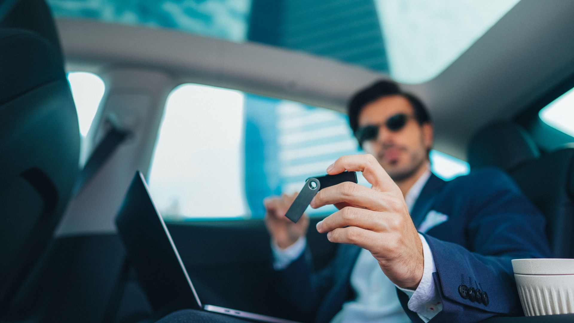 Businessman on travel is using hardware wallet for cryptocurrency