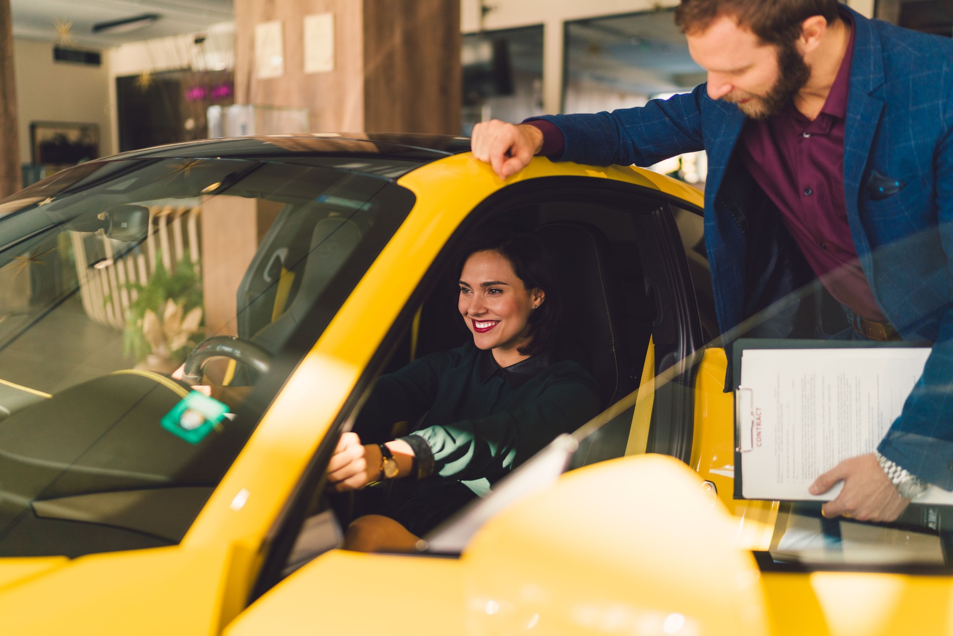 Woman enjoying new car